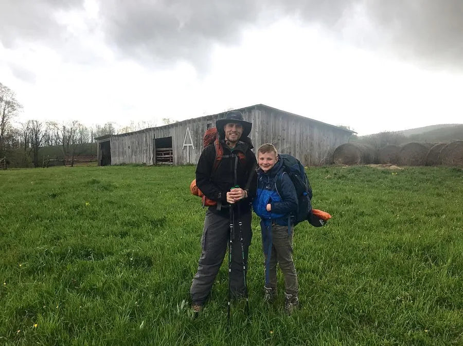 Nate Wells, founder of Brookhaven, with his son at the barn